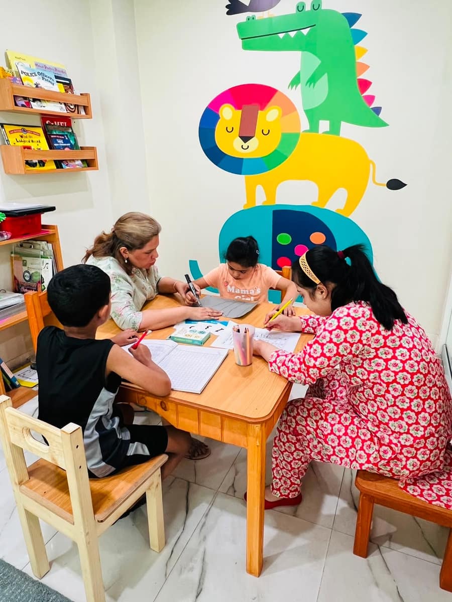 Station-based learning helping a child with ADHD build attention and readiness skills at NEST, Islamabad